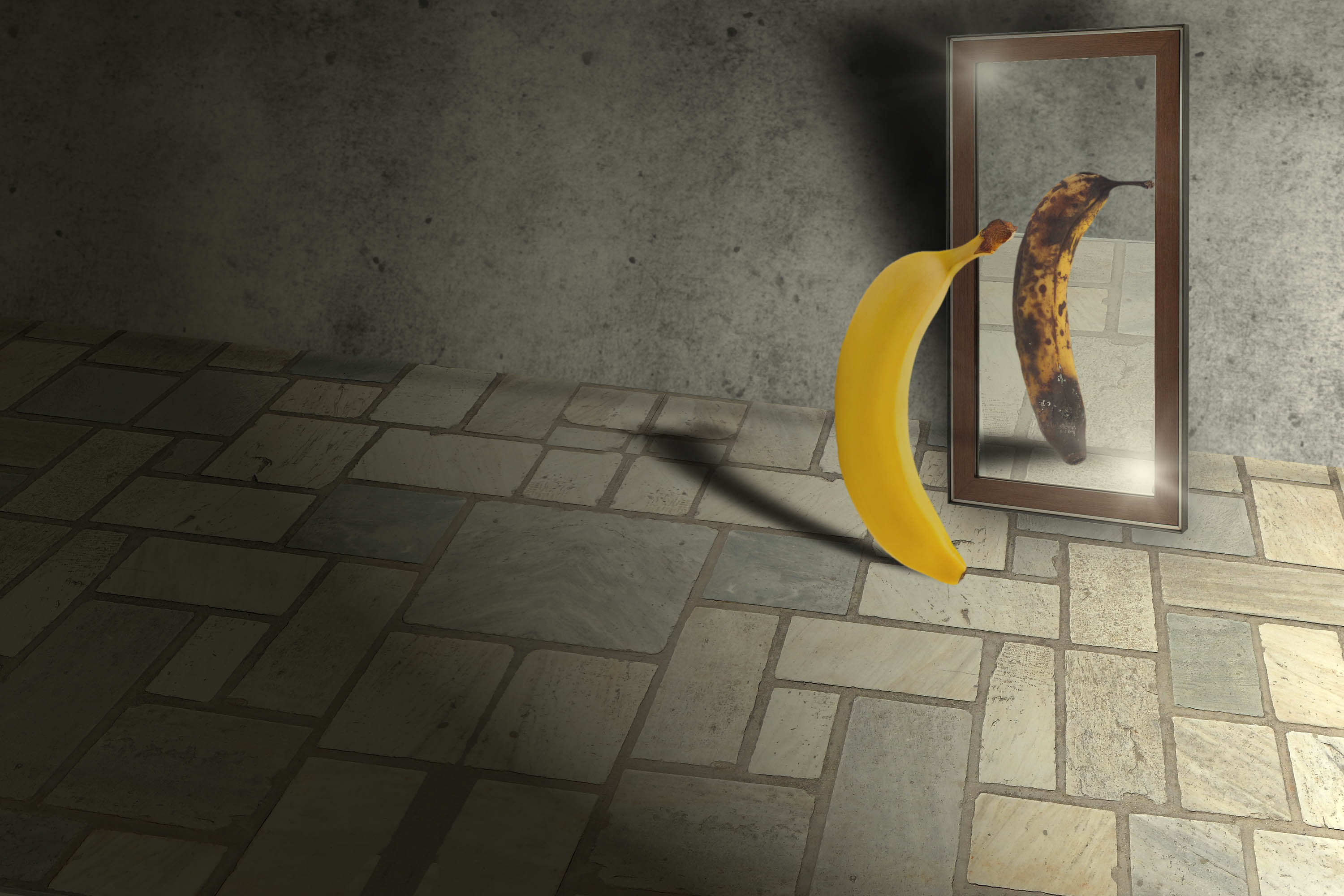 A ripe banana looking in a mirror, rotten banana is reflected back